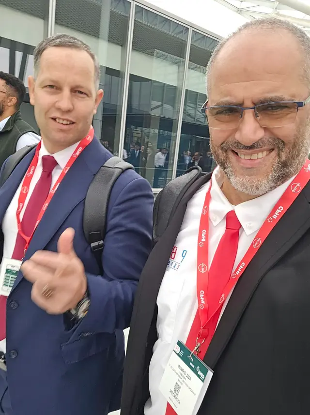 Dr. Aziz Chraibi, wearing his exhibitor badge, in the aisles of CPHI Milan