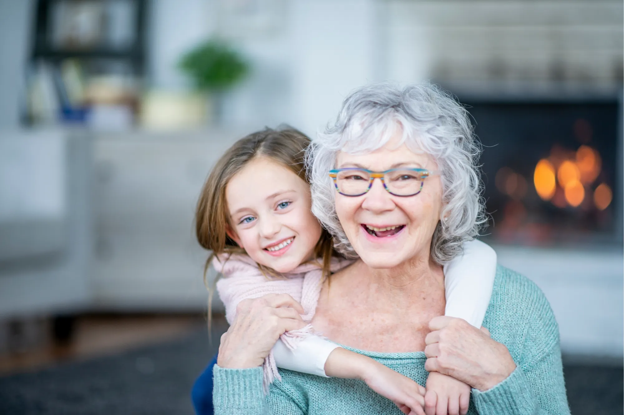 A smiling grandmother hugging her granddaughter