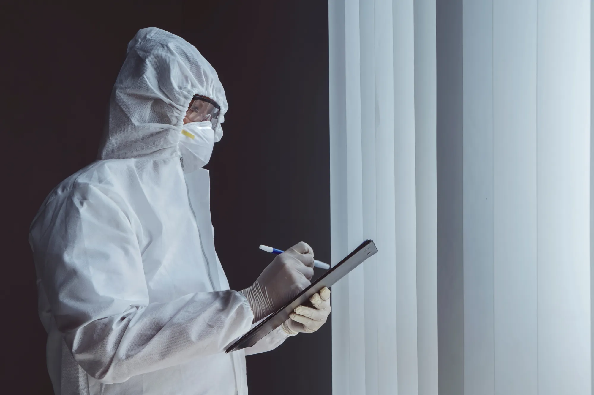 Cleanroom specialist filling in a record on a tablet